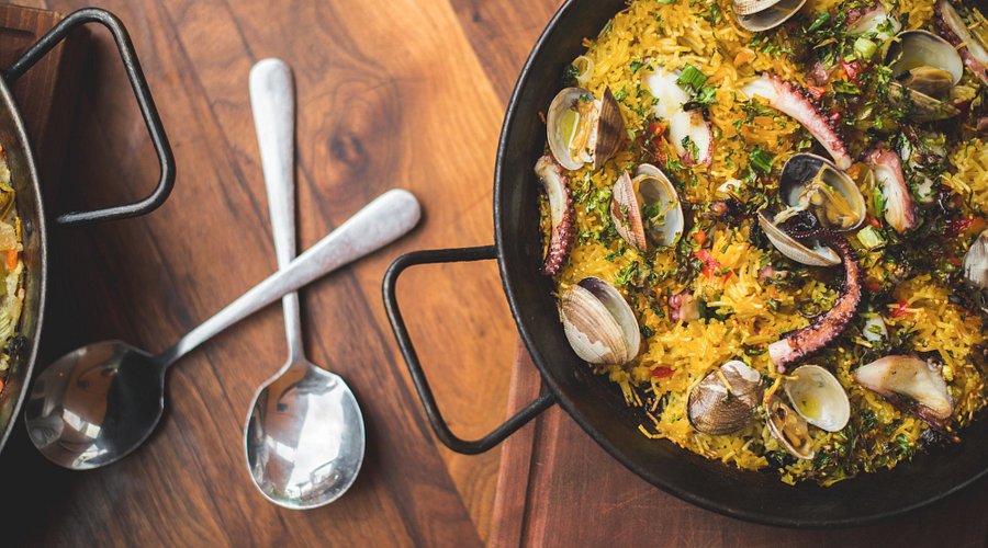 Barcelona Wine Bar signature dishes Seafood Paella, Patatas Bravas, Hanger Steak 